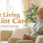 Elderly man relaxing in a bright, cozy apartment-style suite living senior care environment.