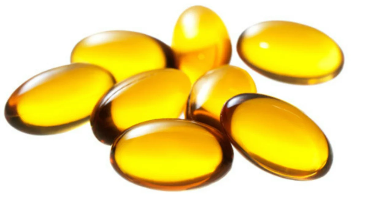 Vitamin E liquid gel capsules grouped together on a white background.