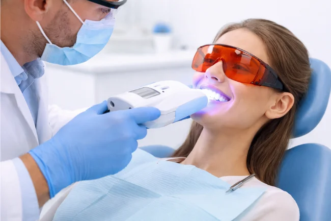 Cost of a teeth whitening shown through an in-office laser teeth whitening procedure at a dental clinic